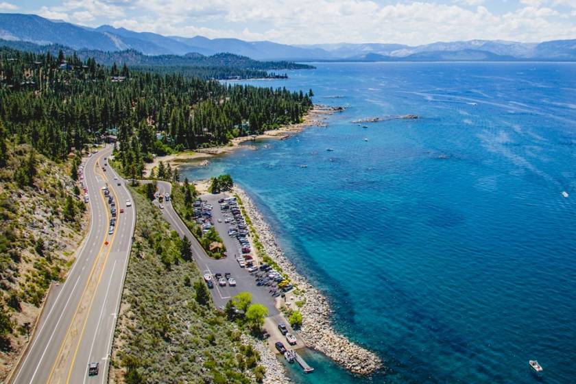 aerial view of road that runs beside Lake Tahoe